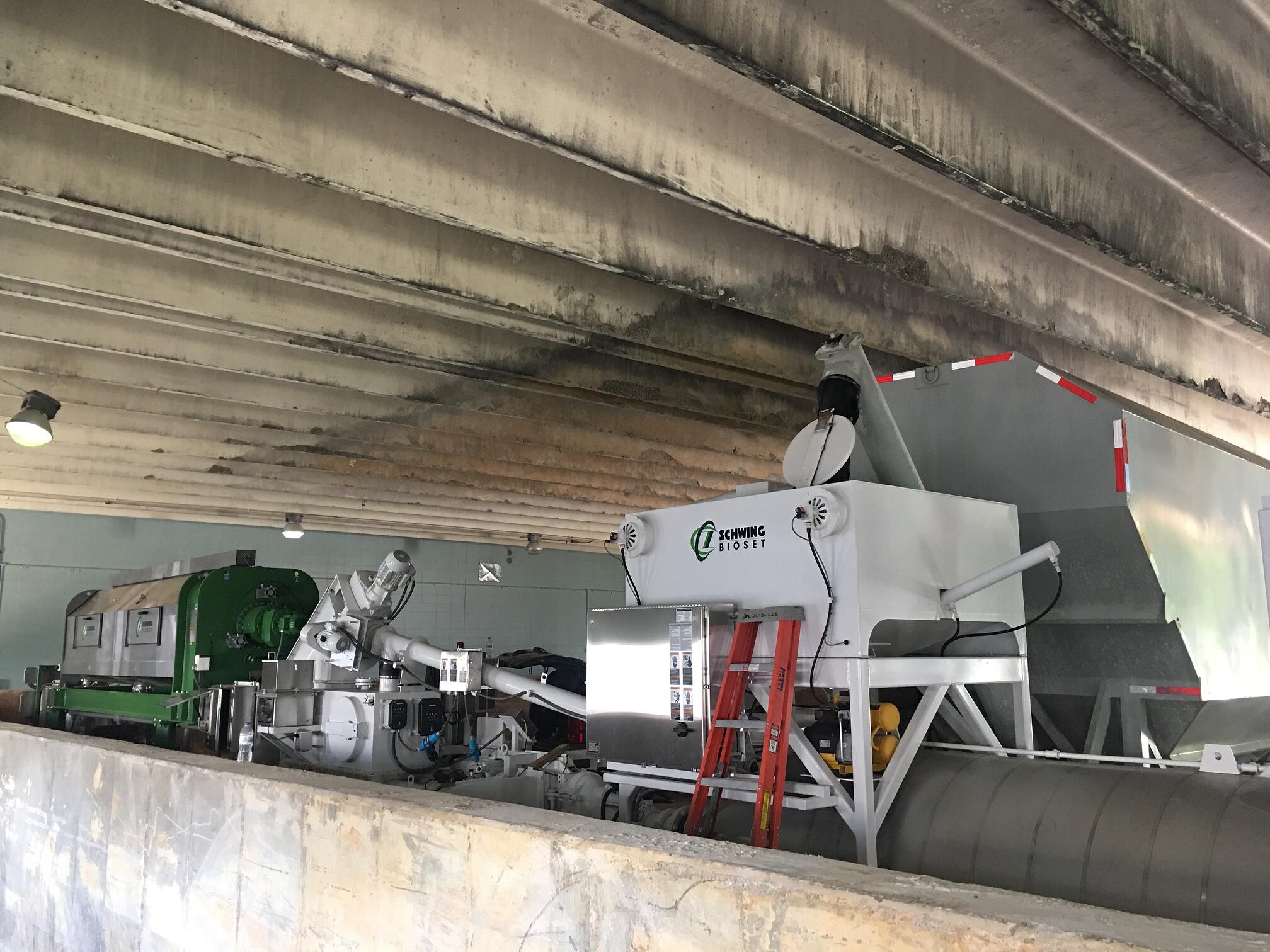 Schwing Bioset mobile screw press dewatering & mobile biosolids handling units in a warehouse