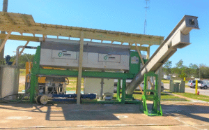 Skid mounted Schwing Bioset screw press on a project site