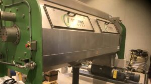 Green and Silver Schwing Bioset dewatering screw press at London, Ohio WWTP.